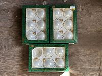 Three boxes of pearl cream white ornaments, full view