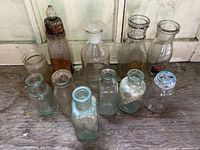 Group of 11 assorted antique and vintage glass bottles and jars