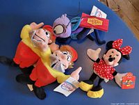 All four Disney plush dolls laid out