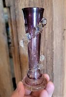 Full view of amethyst glass bud vase with clear applied spiral decoration