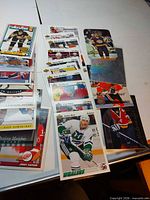 Stacks of assorted NHL cards spread on table