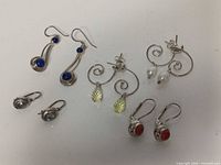 All five pairs of sterling silver gemstone earrings displayed