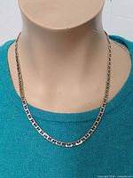 Necklace on display bust showing front view and link style