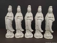 Front view of five matching white porcelain Guanyin figurines