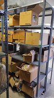 Full view of metal shelving unit loaded with boxes