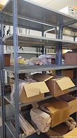 Full view of metal shelving unit loaded with boxes