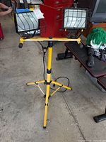 Full view of yellow tripod work light, cord visible