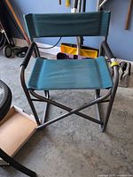 Front view of teal folding director chair