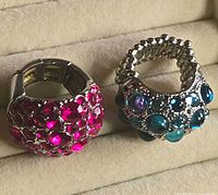 Front view of both rhinestone rings showing stone colors and settings
