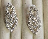 Both clip-on rhinestone earrings displayed in tray