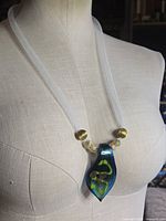Full necklace on mannequin showing pendant and chain