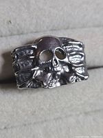 Front view of silver tone skull ring showing skull design