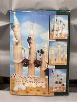 Box front showing three porcelain figurines