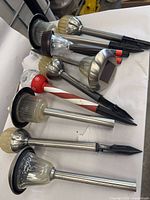 Group of stainless solar stake lights and candy-cane stake light