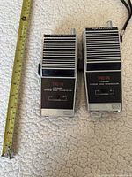 Front view of both Realistic TRC-74 radios with measuring tape for scale