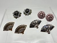 Overall view of four earring pairs arranged on display