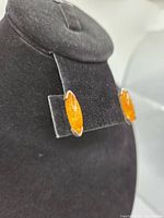 Front view of both amber marquise stud earrings on display