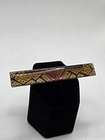 Front view showing geometric design and enamel colors