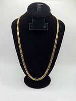 Full view of gold Cuban link chain on display bust