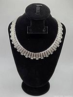 Full view of necklace on bust showing complete fringe design