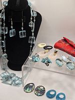 Overview of lot showing crystal parure, floral Coro earrings, interchangeable system and pouch