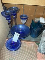 Group view of all blue glass items on shelf