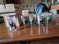 Glasses lined up beside original box showing front graphics