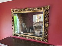 Full view of mirror on wall showing ornate frame and glass