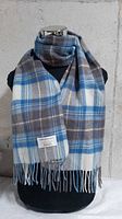 Scarf draped on mannequin showing overall appearance and fringe