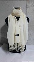 Scarf displayed on mannequin showing overall look and fringe