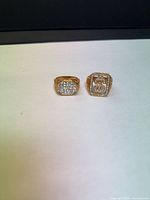 Front view of both gold-tone signet rings showing pavé and square designs