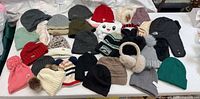 Overview of all winter hats, earmuffs, trapper hat and socks on table