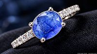 Close-up of ring showcasing sapphire and CZ accents