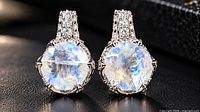 front view of both silver moonstone earrings