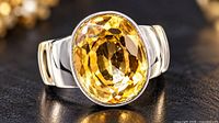 Front angled view of silver ring with citrine stone