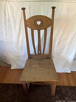front view of solid oak rectory chair with tall back and heart cut-out