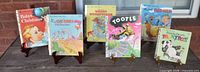 Front view of all six Little Golden Books standing on easels