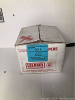 Box containing 25 bags of screws with printed blue label "KIT-SCRWPAK4-03" showing item details and manufacturer