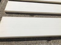 Close-up image showing white primed MDF flat baseboard with smooth edges.