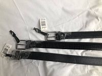 Three men's black belts, new with tags, laid flat showing buckles and leather textures on white background.