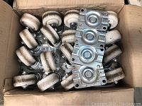 20 nylon swivel wheel castors with metal mounting plates in a cardboard box showing product quantity and condition.