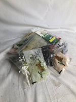 Photo of assorted fishing lures in original clear plastic packaging, some with visible brand names