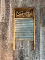 Front of wooden washboard showing Economy Zinc branding and zinc scrubbing surface