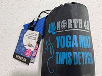 Mat in mesh carry bag with branding and tags visible