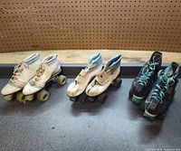 Three pairs of quad skates side by side