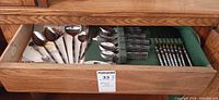 Drawer view showing full assortment of Madrid flatware and placement