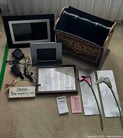 Overview of entire lot showing digital photo frame, power adapters, frames, magazine rack, plaque sign, calla lily wall plaques