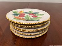 Stack of seven majolica plates showing rim detail and thickness
