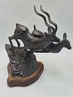 Full view of bronze antelope sculpture on wood base