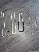 All six necklaces laid flat showing full length and design